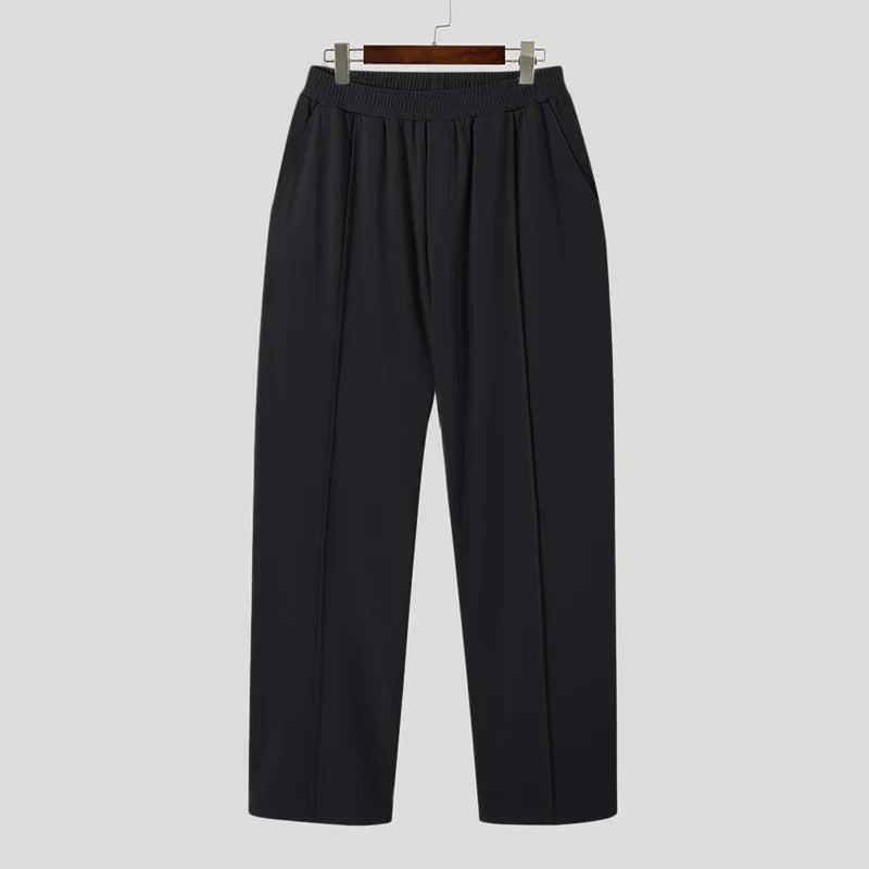 Man wearing Verona Pleated Dress Trousers, demonstrating comfortable fit and elegant drape.