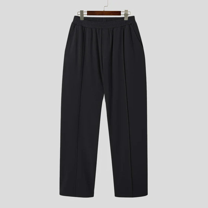 Man wearing Verona Pleated Dress Trousers, demonstrating comfortable fit and elegant drape.