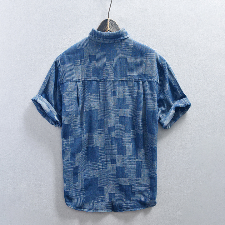Cool men's black denim shirt with chest pockets & button-down design, ideal for versatile casual outfits.