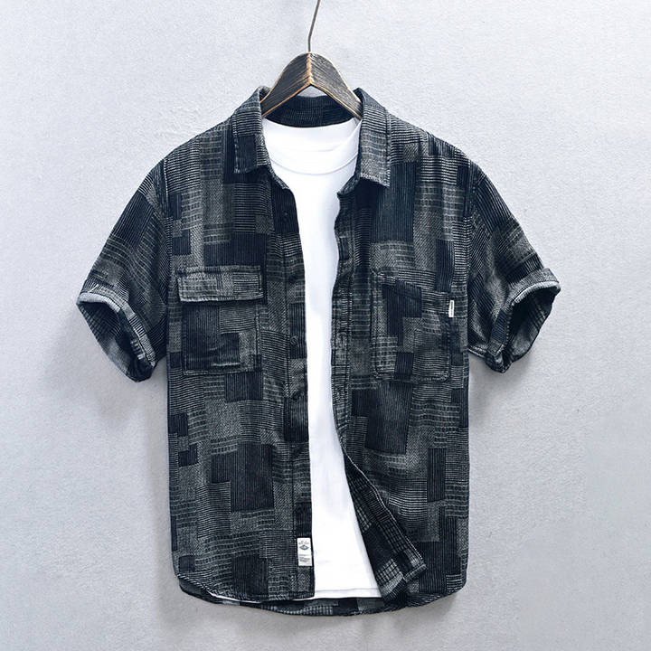 Casual men's blue denim shirt featuring a relaxed fit & button-down style, great for everyday summer fashion.