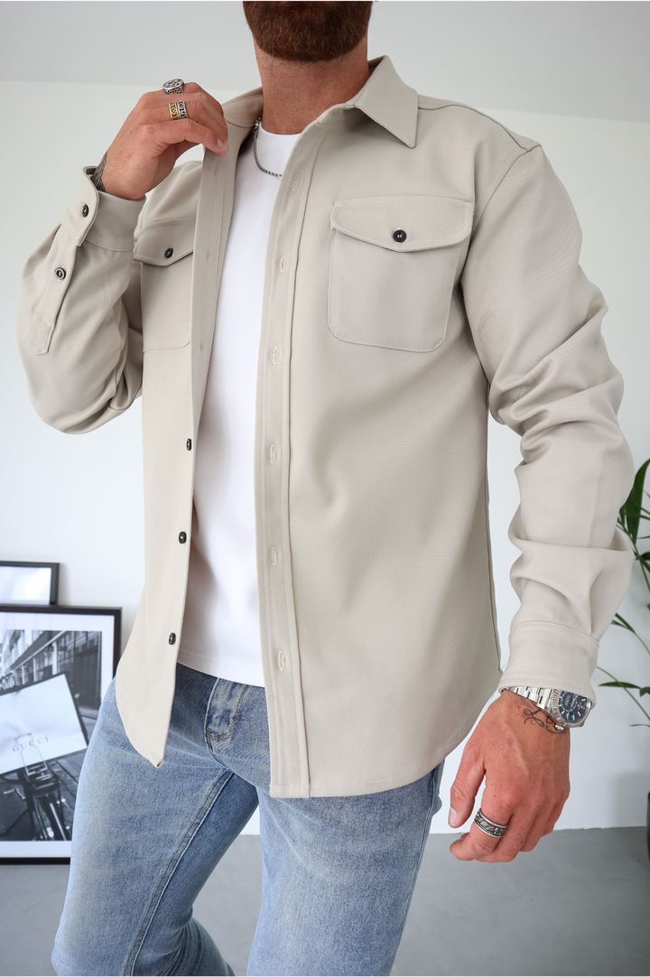 Men's button-up overshirt jacket featuring practical chest pockets; a versatile long sleeve layering piece.