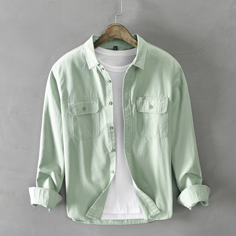 Modern men's long-sleeve button-up shirt with practical chest flap pockets, offering a relaxed fit for daily wear.