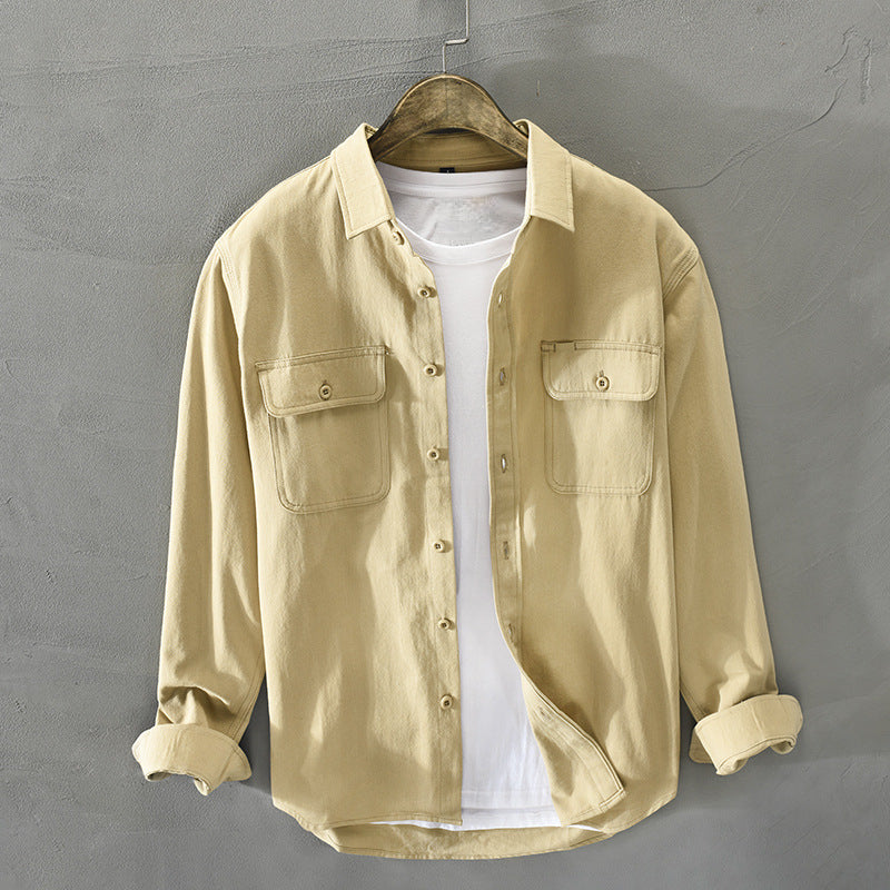 Stylish men's button-up shirt, long sleeves, flap pockets, designed for versatile casual wear & a relaxed fit.