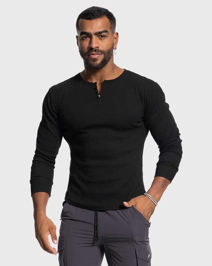 Men's long sleeve henley with button neck, ribbed fabric, ideal for layering or casual style.