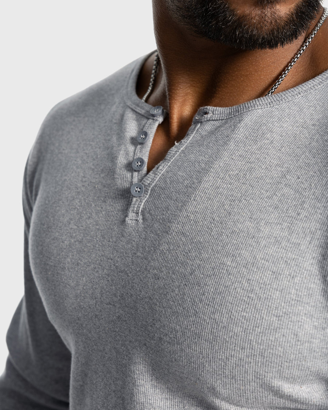 Close-up of button neck on a men's long sleeve rib knit henley shirt.