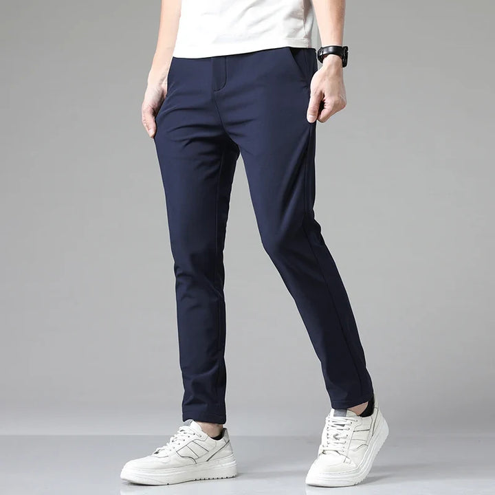 Man in grey straight fit casual pants, demonstrating flexible movement and all-day comfort.