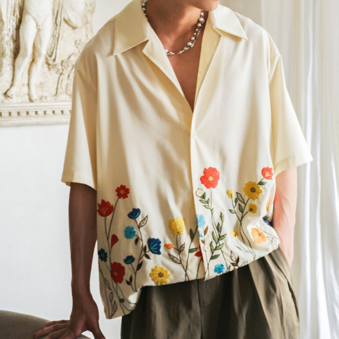 Men's vibrant floral button-up shirt. Stylish short-sleeve comfort for summer parties & casual wear.