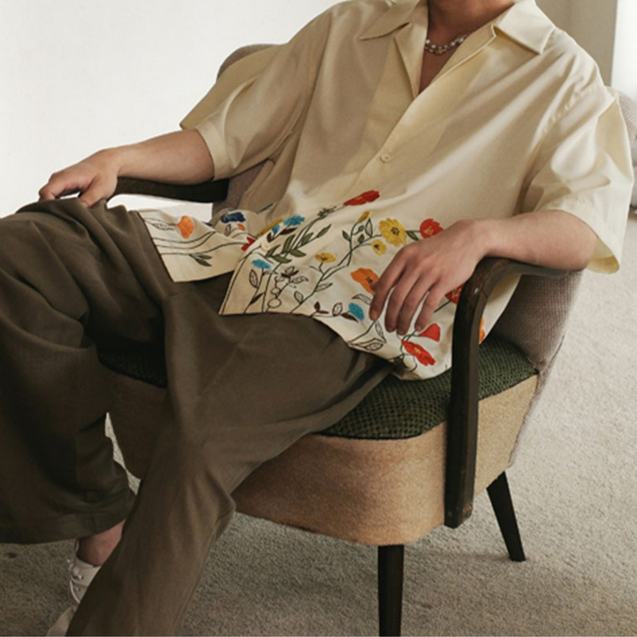 Men's vibrant floral button-up. Short-sleeve, comfortable, and stylish for casual or party wear.