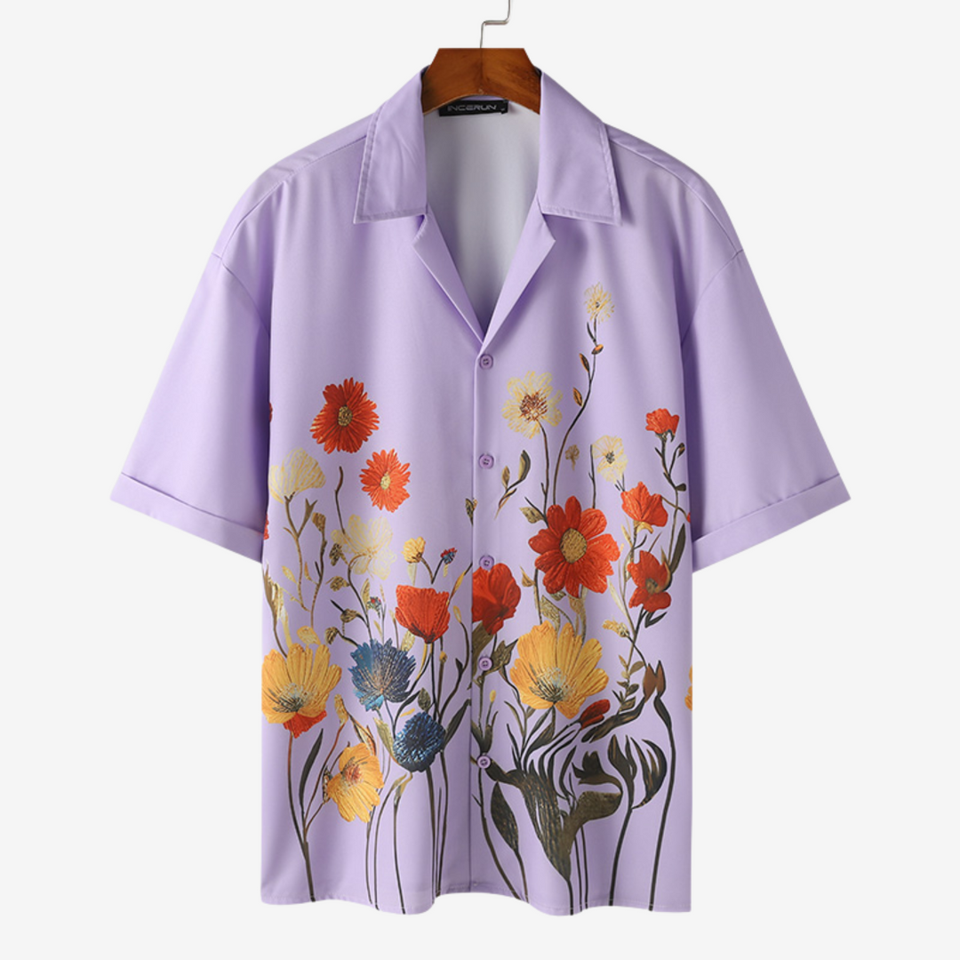 Close-up of a men's vibrant floral button-up shirt, showcasing the colorful print & stylish design.
