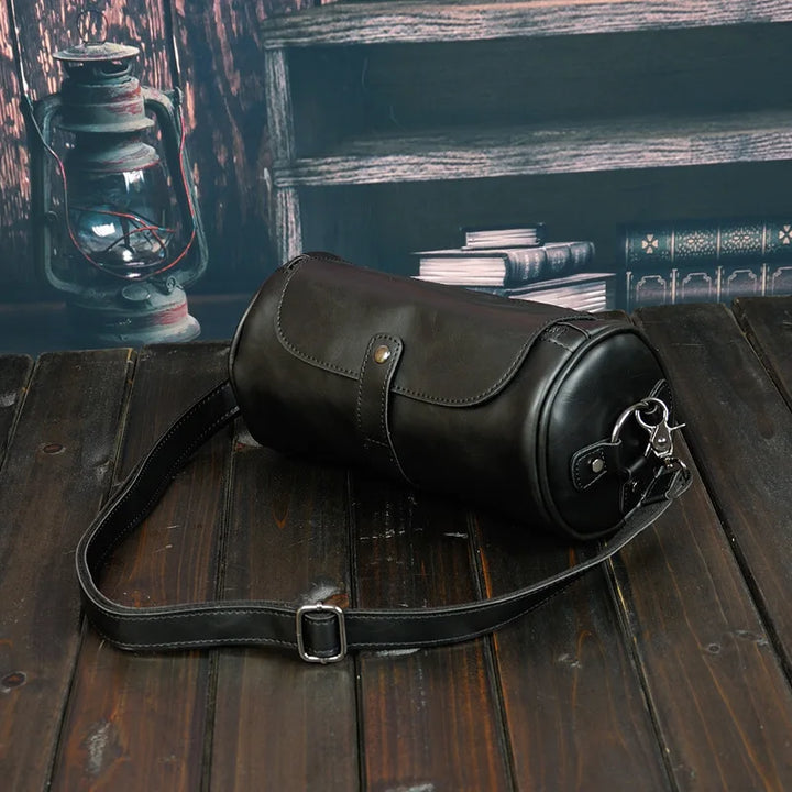 Durable men's barrel shoulder bag for daily essentials, vintage PU leather, adjustable crossbody strap.