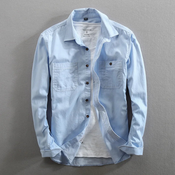 Light blue men's vintage urban polo, short sleeve with dual chest pockets. Perfect for casual wear.