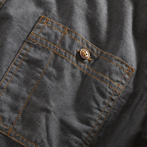 Men's short-sleeve vintage polo shirt with stylish dual chest pockets, urban fashion essential.