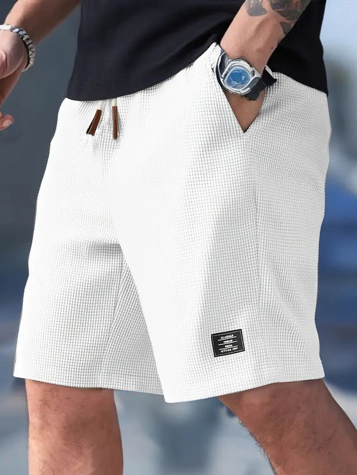 Essential men's waffle knit shorts, relaxed fit, providing ultimate comfort & casual style for summer fashion.