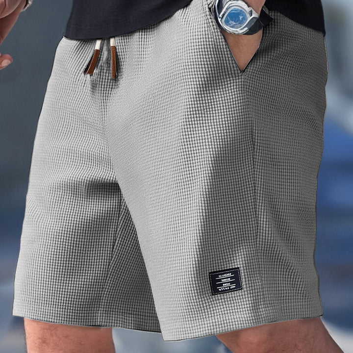 Close-up of men's waffle knit shorts texture, relaxed fit, highlighting soft, breathable fabric for ultimate comfort.