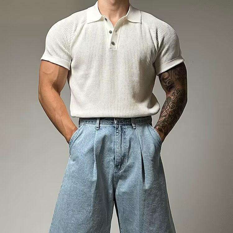 Close-up of men's waffle knit polo shirt fabric. Textured short sleeve casual wear.