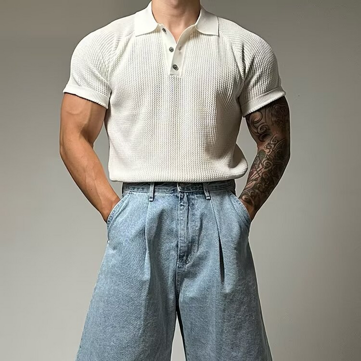Close-up of men's waffle knit polo shirt fabric. Textured short sleeve casual wear.