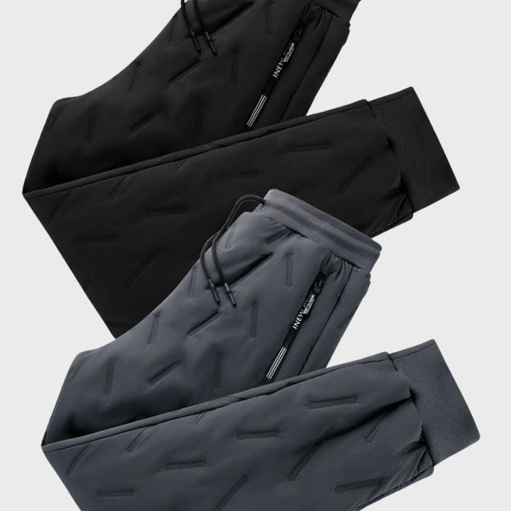 Black slim fit men's winter pants, warm and comfortable with a tapered leg for outdoor adventures.