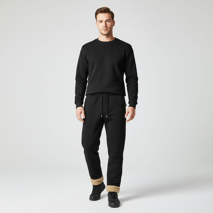 Pair of folded men's warm joggers, showing elastic waistband and cuffed ankles, cozy winter apparel