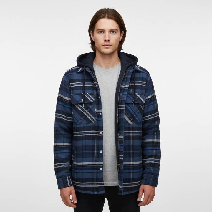 Man smiling, wearing a comfortable men's checkered hooded jacket, outdoor setting.