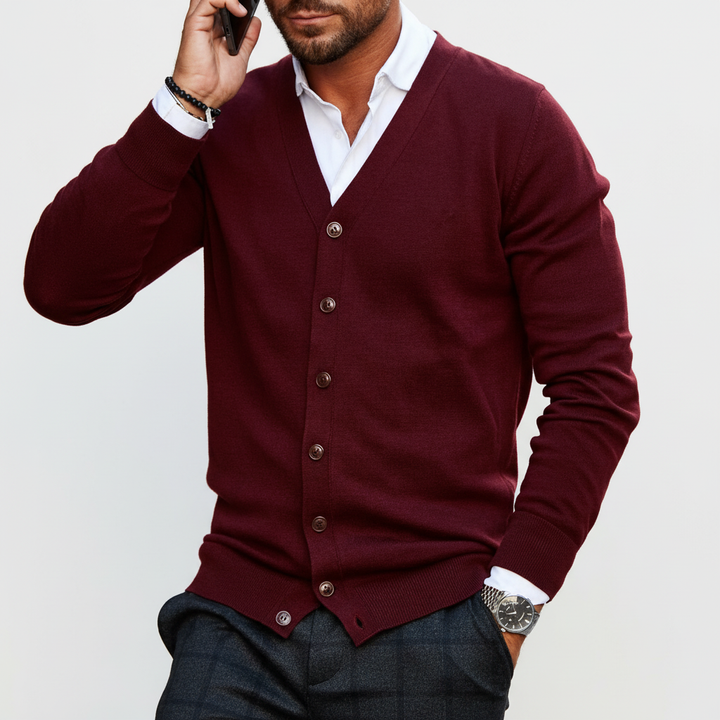 Closeup of a gray men's button-front knit cardigan, highlighting the detailed warm sweater texture.