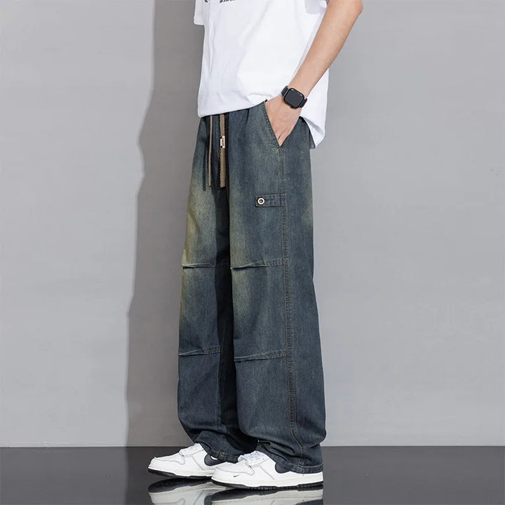 Comfortable men's washed wide-leg jeans. Relaxed fit denim with practical drawstring for casual fashion.
