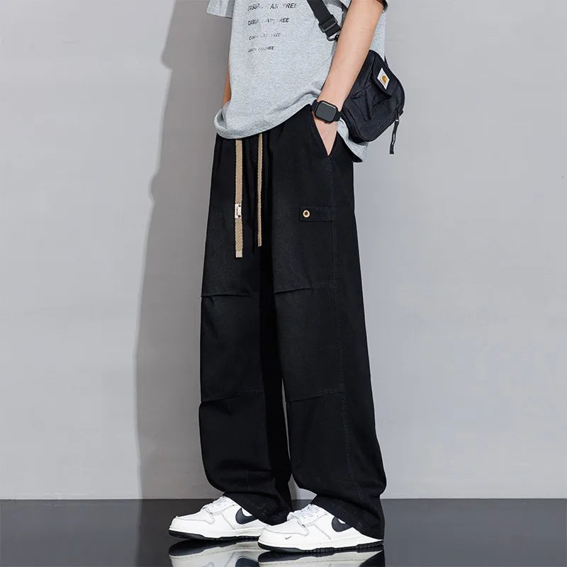 Back view of men's wide-leg washed jeans, relaxed fit with drawstring waist, showcasing casual style.