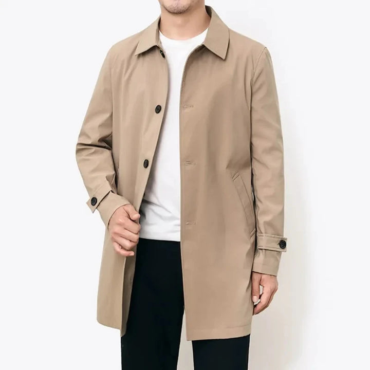 Close-up of men's water-repellent trench overcoat fabric, showing durable, all-weather material for transitional style.
