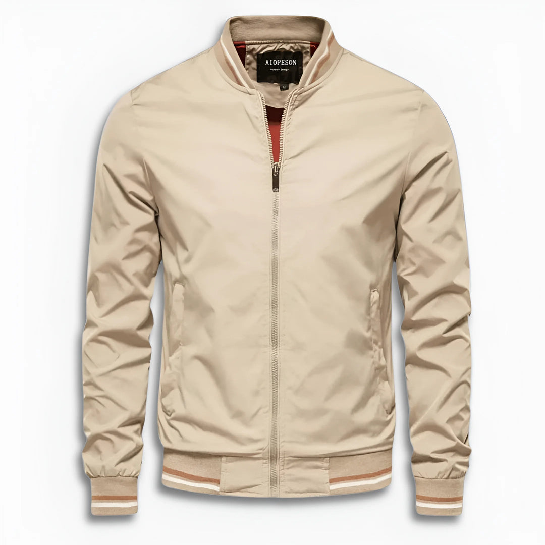 Full-body shot of a man wearing a water-repellent transition jacket with stand-up collar. Casual fit.