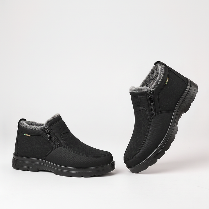 Model wearing black men's waterproof insulated winter boots, cold weather-ready