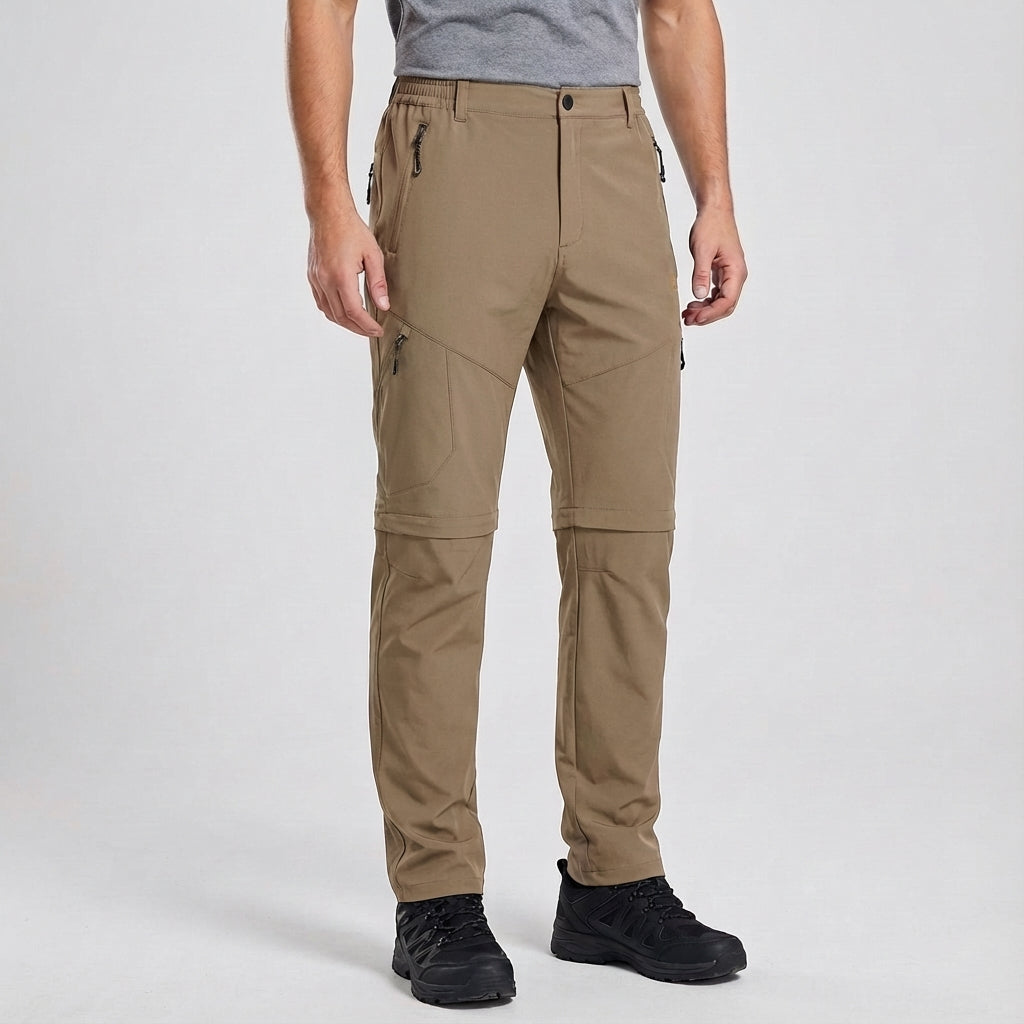 Detail of the zipper and pockets on men's convertible waterproof hiking trousers, practical for trekking.