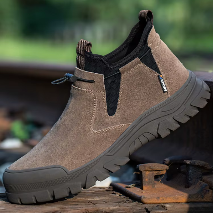 Close-up: Rugged leather West Ridge men's steel-toe slip-on work boots, durable construction.