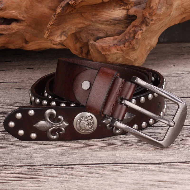 Black men's western belt, studded leather design, featuring an antique silver fleur-de-lis buckle. Rustic accessory.