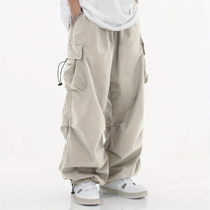 Close-up: Men's wide-leg cargo pants with utility pockets & adjustable cuffs. Tactical & casual fashion.