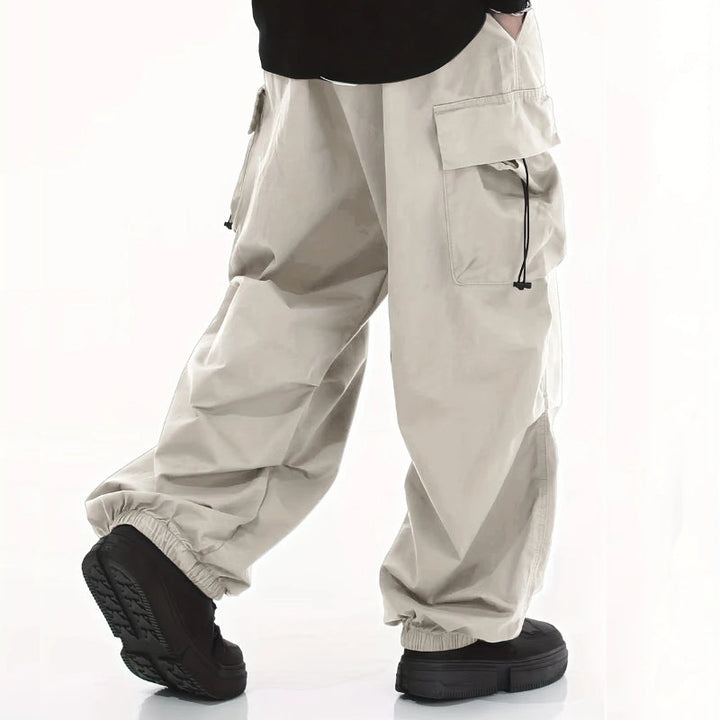 Rugged men's wide-leg cargo pants, designed for outdoor adventures. Durable, comfortable, tactical style.