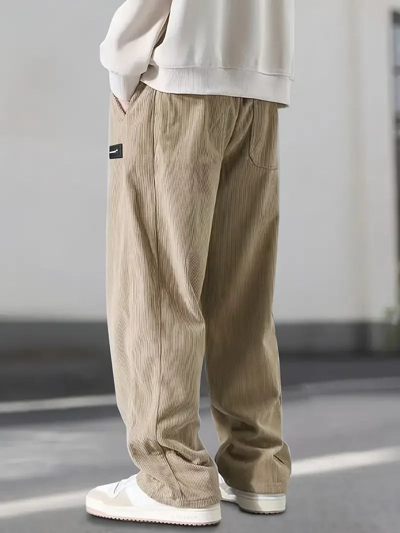 Comfortable men's wide leg corduroy pants with elastic adjustable waist for a relaxed fit and soft texture.