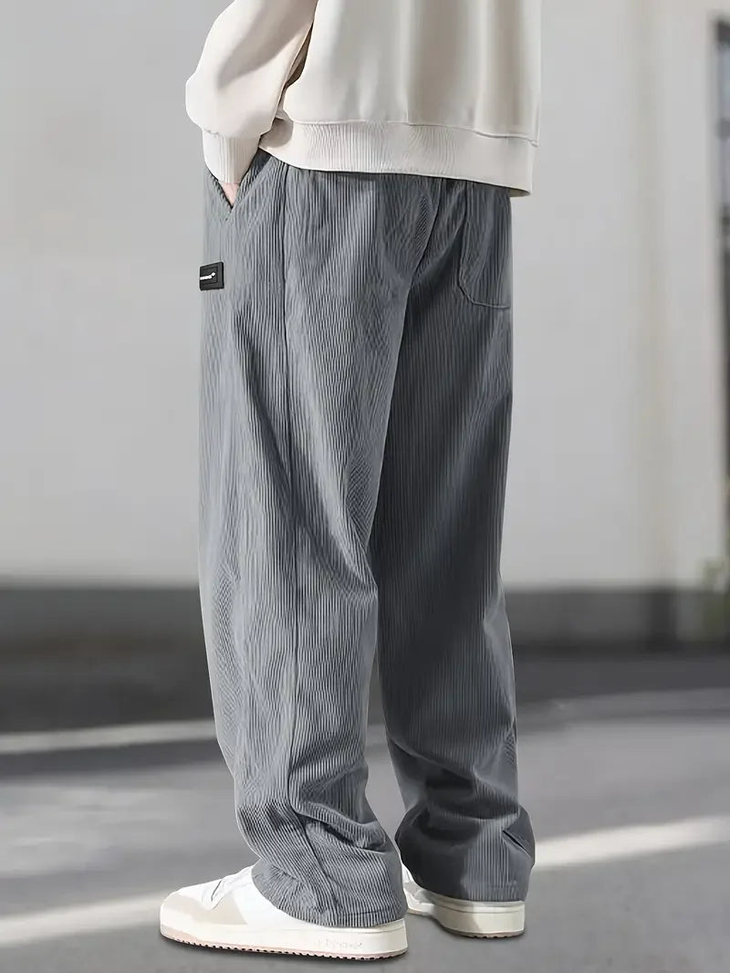 Front view: Men's wide leg corduroy pants, elastic waist, relaxed fit, showing comfortable streetwear style.
