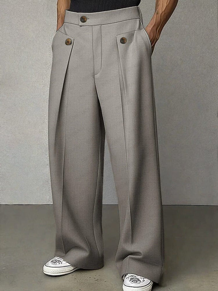 Full-length view of men's modern wide-leg pleated trousers, showcasing relaxed fit & effortless style.