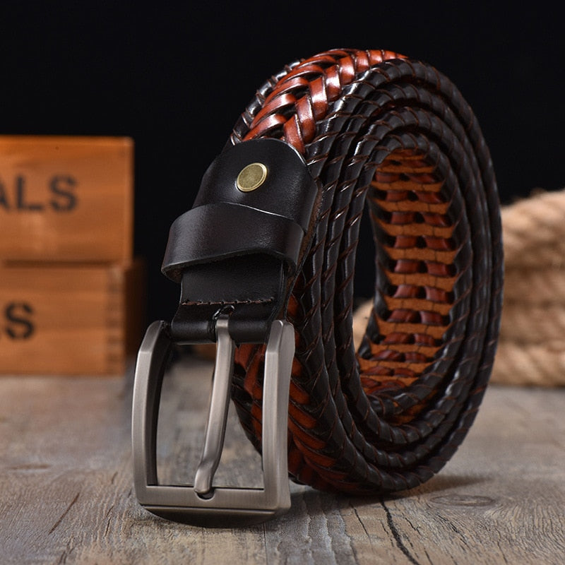 Close-up of a braided cowhide leather belt for men, featuring a sleek polished metal buckle.