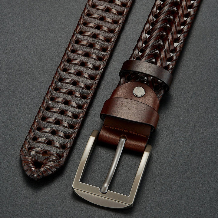 Detailed view of the intricate weave texture of a men's cowhide leather belt with polished buckle.