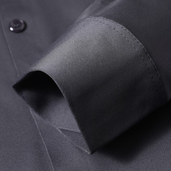 Model wearing a comfortable, timeless men's wrinkle-free dress shirt, ideal for office or evening events.
