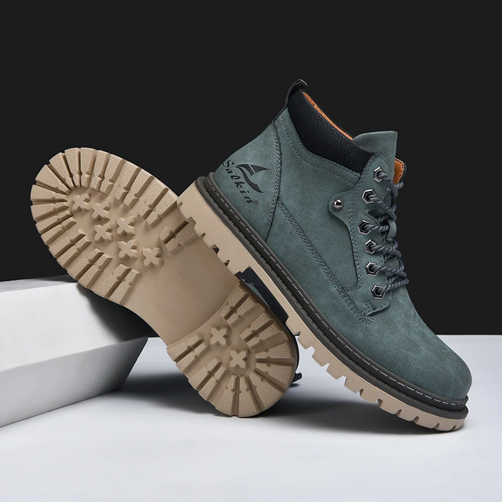 Close-up on the robust stitching of mens durable boots, built for rugged outdoor and urban adventures.