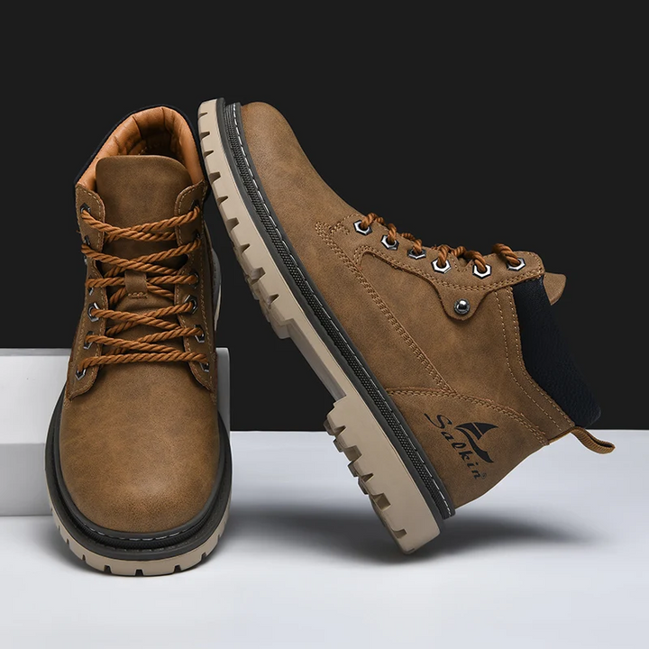 Front view of mens rugged outdoor boots. All-terrain design provides durability & traction for adventure.