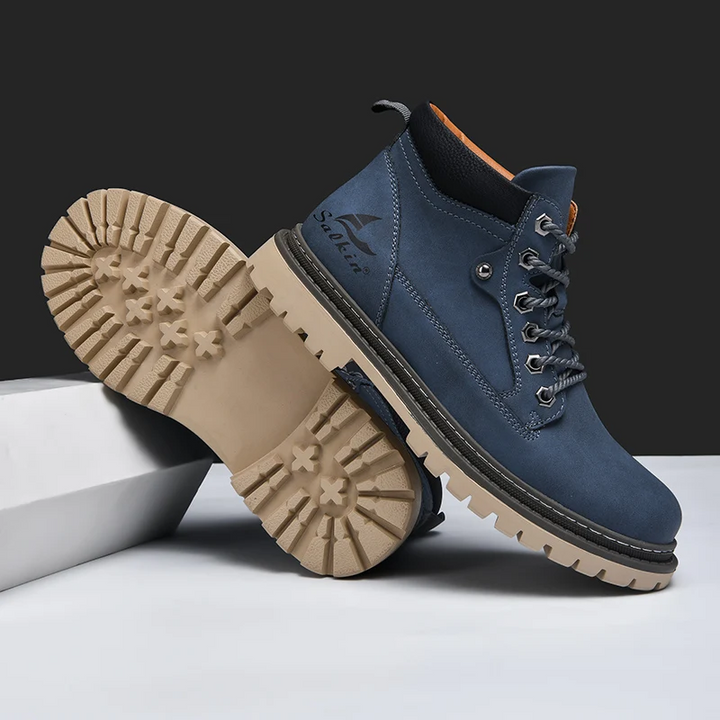 Mens all-terrain boots in an urban setting, combining adventure readiness with casual style.