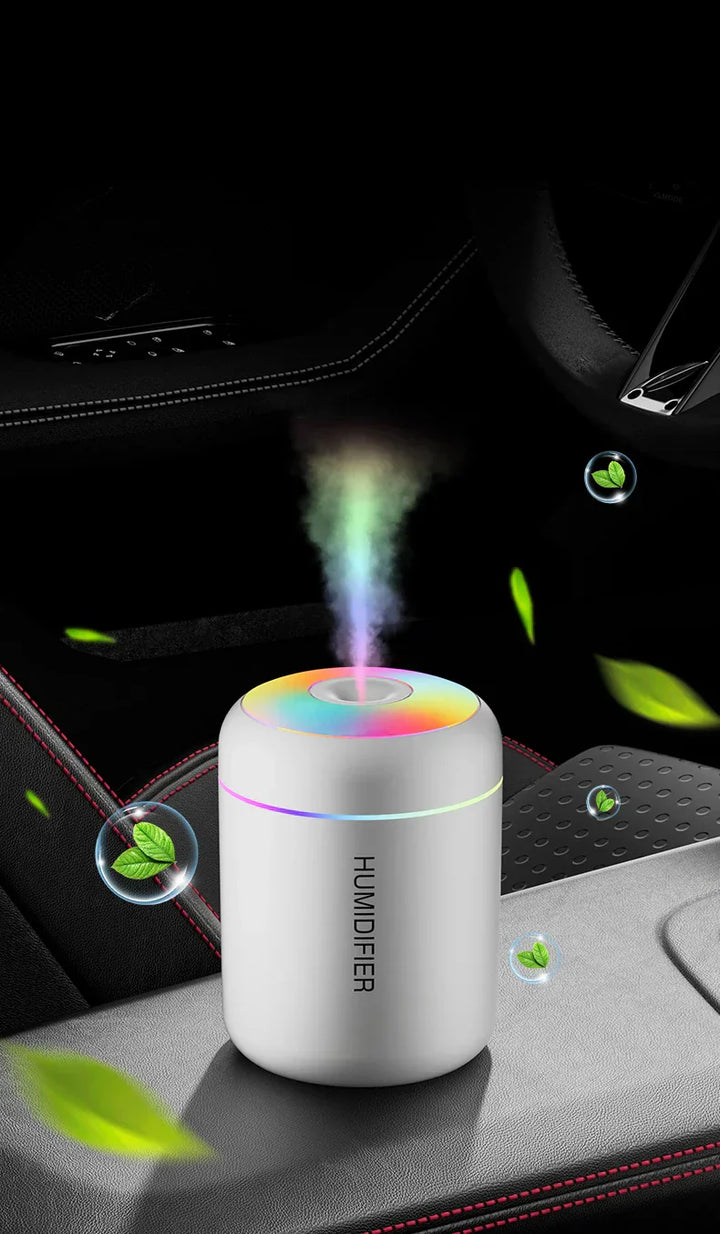 Product shot of mini USB humidifier & diffuser from above, showing sleek white design & mist