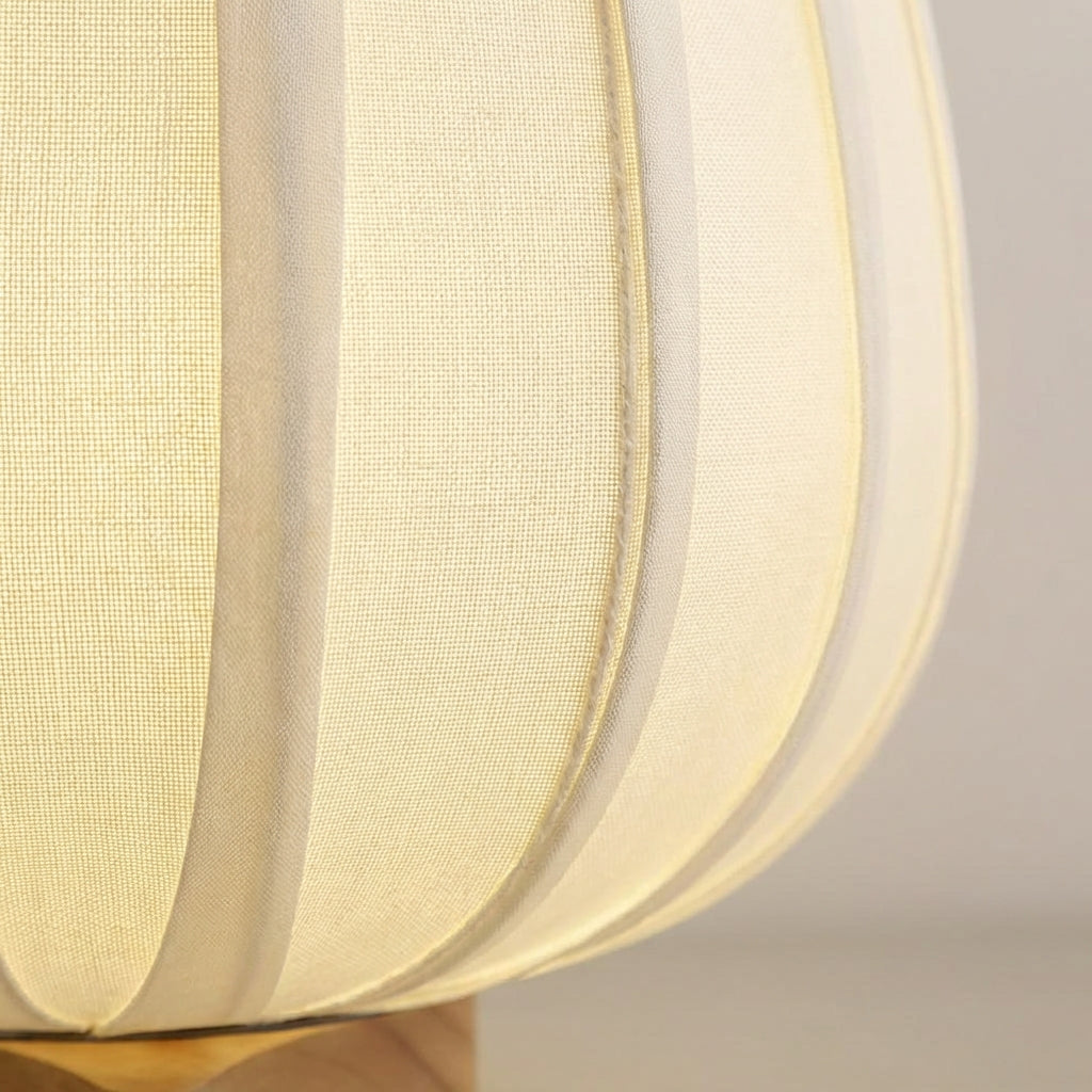 Close-up of AmbiNook minimalist table lamp showing natural bamboo grain and textured fabric shade