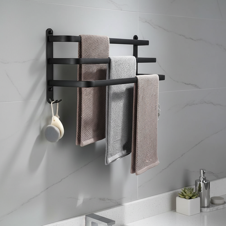 Minimalist black metal towel holder mounted on a neutral bathroom wall, space-saving design.