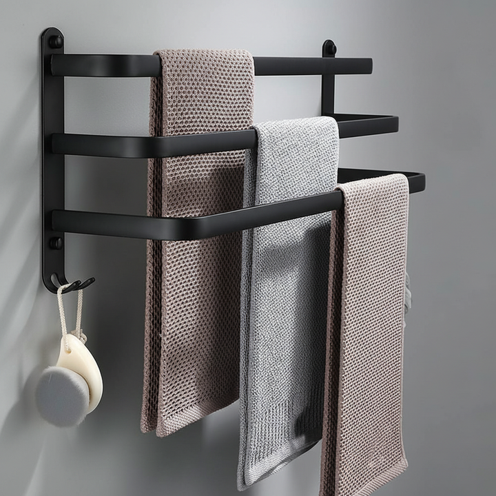 Durable wall-mounted metal towel holder for bathroom organization, holding a white towel.