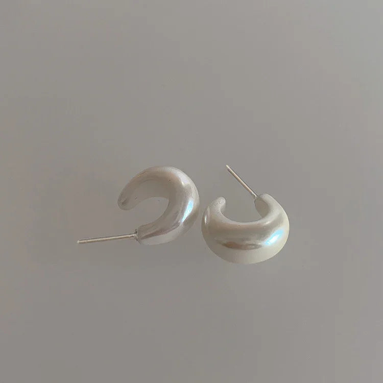 Women's sterling silver C-shape pearl earrings, minimalist design, perfect for everyday elegance.