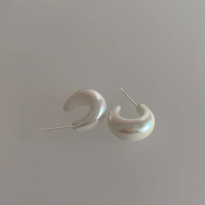 Women's sterling silver C-shape pearl earrings, minimalist design, perfect for everyday elegance.