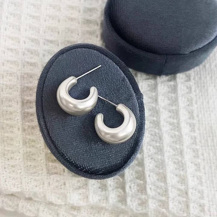 Delicate hypoallergenic C-shape pearl earrings for women, minimalist sterling silver jewelry.